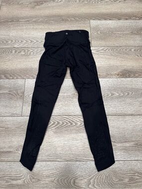 Lululemon leggings Size 4 with perforations at the bottom.